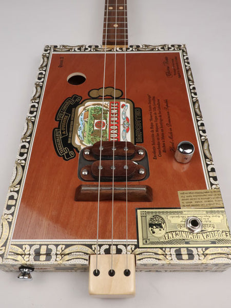Front view of a 3 string cigar box guitar made with a Queen B Fuente cigar box. This cigar box guitar is handmade by Mike Snowden of Snowden Guitars.