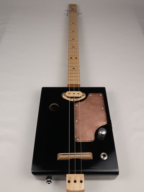 Cigar box guitar with copper pick guard and maple neck. Handmade by Mike Snowden for sale.