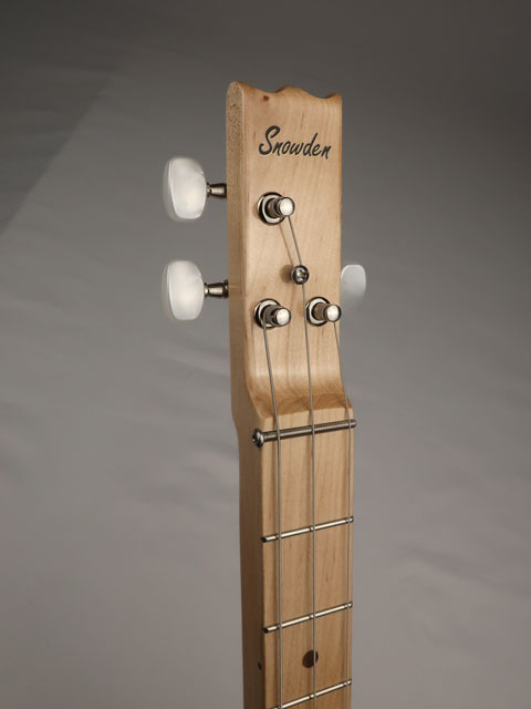 Close up headstock with logo of a 3 string cigar box guitar. Snowden guitars logo shown on front of headstock.