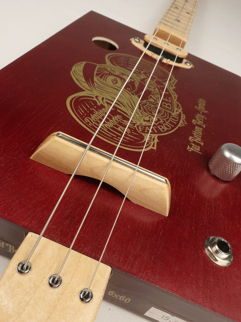 Front side angle of a 3 string cigar box guitar with maple bridge. Handmade by Mike Snowden.