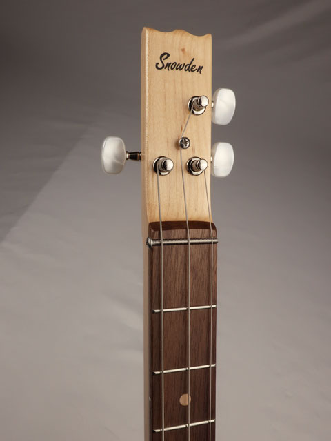 3 string cigar box guitar headstock with Snowden guitars logo on the front. Maple and walnut neck made by Mike Snowden.