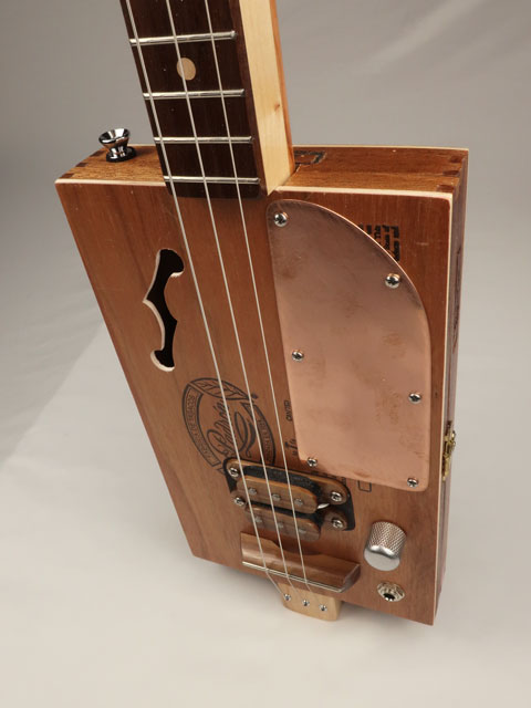 Padron cigar box guitar with copper pick guard and humbucker pickup. Handmade by Mike Snowden.