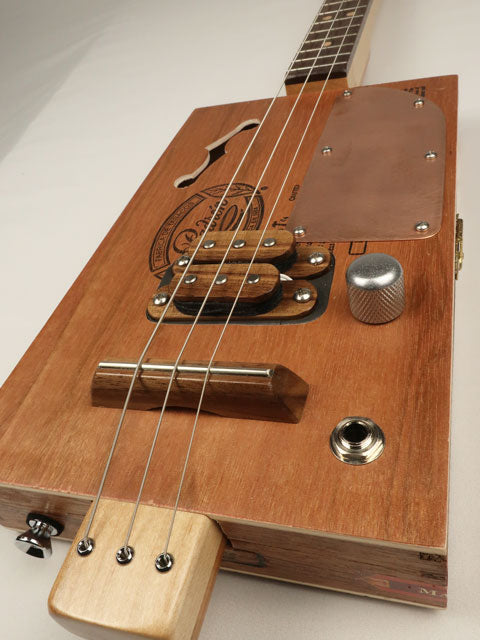 3 String cigar box guitar with humbucker pickup and copper pick guard. Handmade by Mike Snowden.