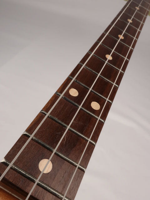 Front tilted view of a 3 string cigar box guitar neck with walnut fretboard handmade by Mike Snowden of Snowden Guitars.