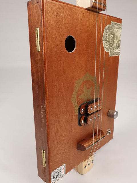 Front view of a 3 string cigar box guitar made with a StillWell Star cigar box. This cigar box guitar is made with a sapele fretboard and maple inlay by Mike Snowden of Snowden Guitars.