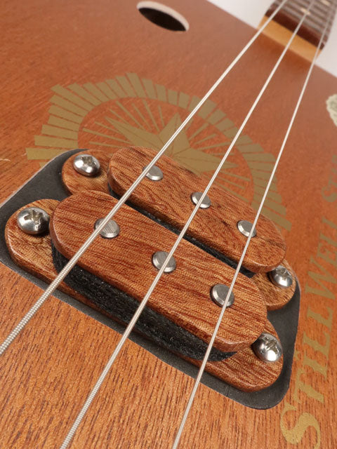 Close up view of a 3 string cigar box guitar humbucker made with a StillWell Star cigar box. This cigar box guitar is made with a sapele fretboard and maple inlay by Mike Snowden of Snowden Guitars.