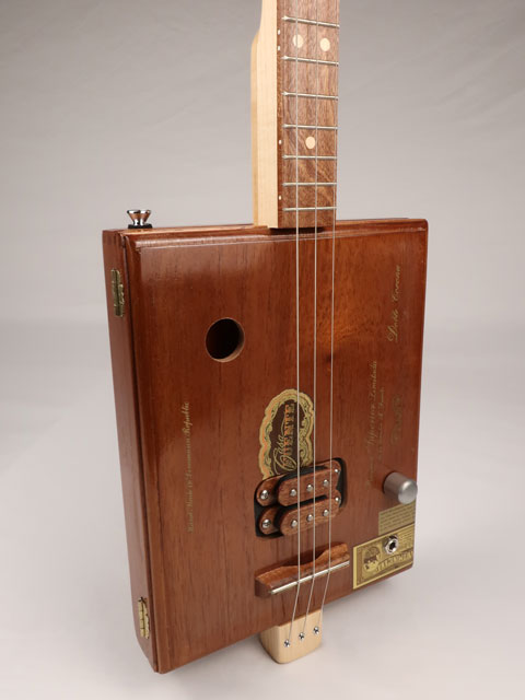 Front tilted view of a Fuente 3 string cigar box guitar made with a maple neck sapele fretboard handmade by Mike Snowden of Snowden Guitars.