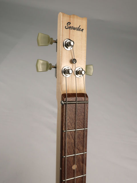 Front view of a 3 string cigar box guitar headstock with a Snowden Guitars logo on the front.