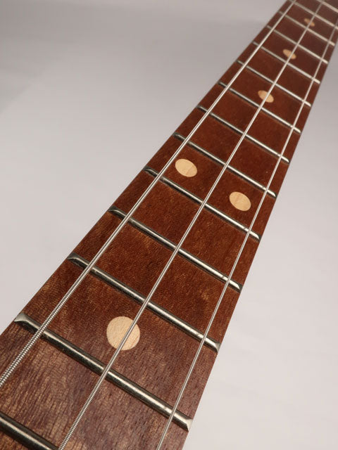 Front view of a 3 string cigar box guitar with a sapele fret board handmade by Mike Snowden of Snowden Guitars.