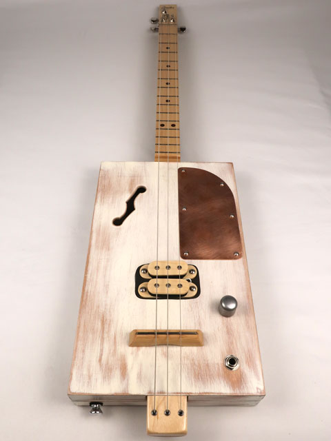 Front view of a 3 string cigar box guitar made with a humbucker pickup and copper pick guard. This cigar box guitar is handmade by Mike Snowden of Snowden Guitars.