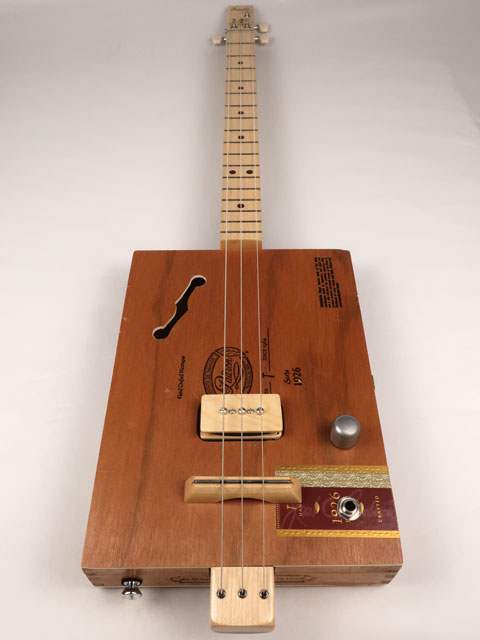 Front view of cigar box guitar with a P90 pickup handmade by Mike Snowden. This cigar box guitar is made with a Padron cigar box and a maple neck.