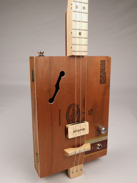 Front view of cigar box guitar with a P90 pickup handmade by Mike Snowden. This cigar box guitar is made with a Padron cigar box and a maple neck.