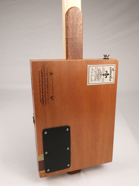 Back view of cigar box guitar with a P90 pickup handmade by Mike Snowden. This cigar box guitar is made with a Padron cigar box and a maple neck.