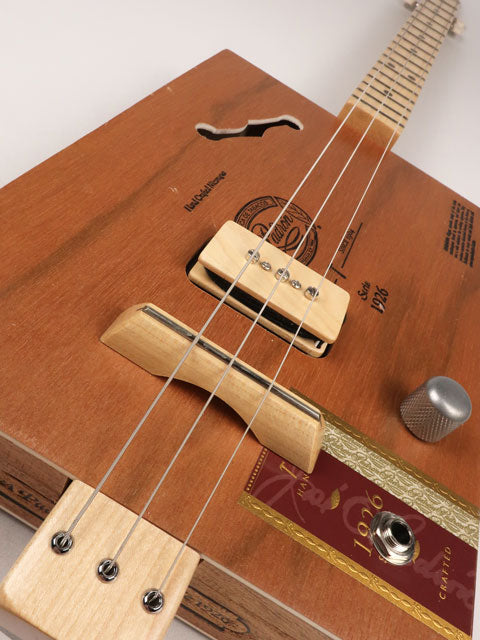 Tilted front view of cigar box guitar with a P90 pickup handmade by Mike Snowden. This cigar box guitar is made with a Padron cigar box and a maple neck.