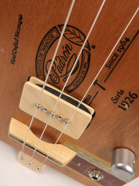 Close up front view of cigar box guitar with a P90 pickup handmade by Mike Snowden. This cigar box guitar is made with a Padron cigar box and a maple neck.
