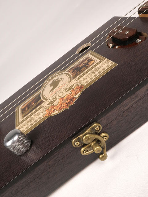 Side view of a cigar box guitar latch on a 3 string cigar box guitar handmade by Mike Snowden of Snowden Guitars.