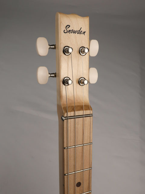 Front view of a 4 string cigar box guitar with a Snowden Guitars logo on the front of the headstock. This cigar box guitar is handmade by Mike Snowden of Snowden Guitars.