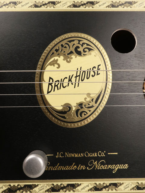 Close up view of a 4 string cigar box guitar made with a Brick House cigar box. This cigar box guitar is made with a maple single coil pickup handmade Mike Snowden of Snowden Guitars.