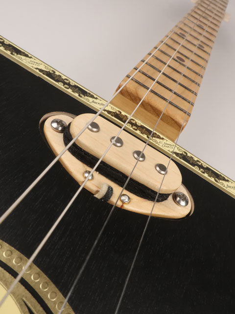 Close up view of a single coil pickup 4 string cigar box guitar made with a Brick House cigar box. This cigar box guitar is made with a maple single coil pickup handmade Mike Snowden of Snowden Guitars.