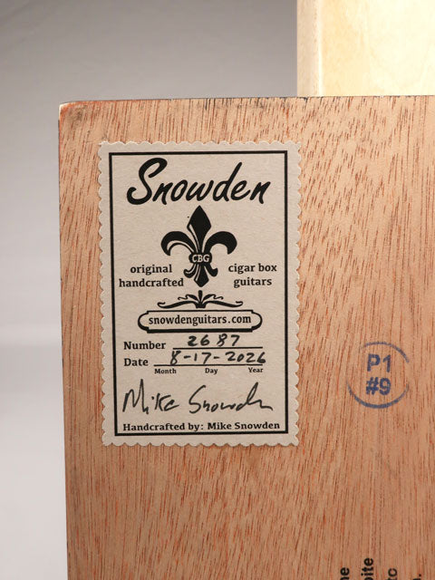 Back view of a cigar box guitar label with date and number of guitars made by Mike Snowden of Snowden Guitars.