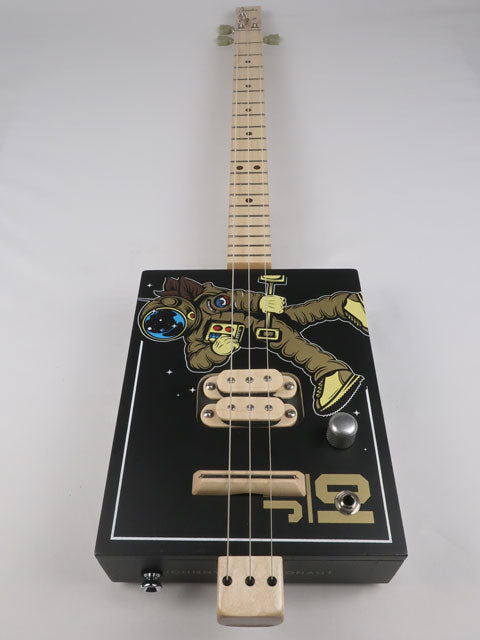 Front view of a 3 string cigar box guitar with an astronaut space suit on the front. Maple neck and maple humbucker pickup handmade by Mike Snowden of Snowden Guitars.