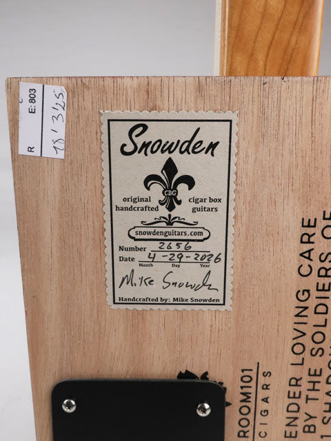 Back view of a cigar box guitar with a Snowden Guitars sticker on the back. The sticker shows the date and number of when this cigar box guitar was made.