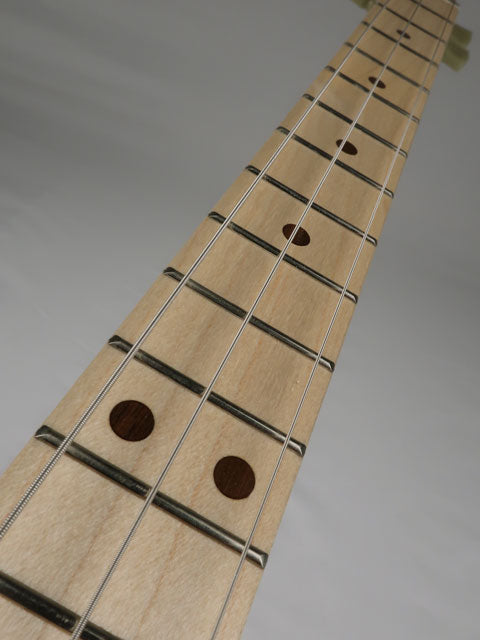 Front view of a cigar box guitar fretboard. This maple neck and maple fretboard and Grover Tuners is handmade by Mike Snowden of Snowden Guitars.
