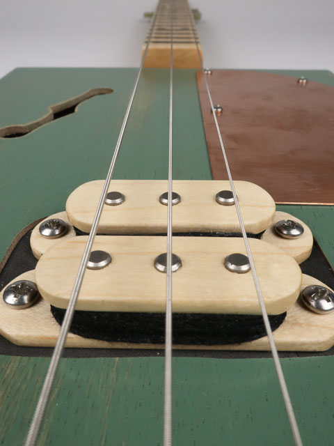 Close up view of a cigar box guitar humbucker pickup made from maple wood. This cigar box guitar is made by Mike Snowden of Snowden Guitars.