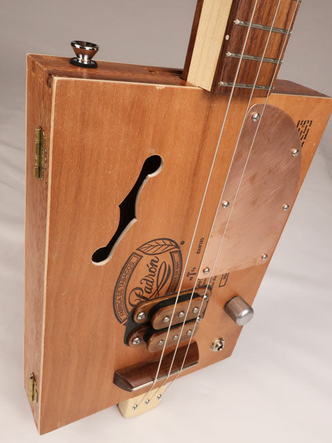 Front tilted view of a 3 string cigar box guitar made with a Padron cigar box. Handmade by Mike Snowden of Snowden Guitars.