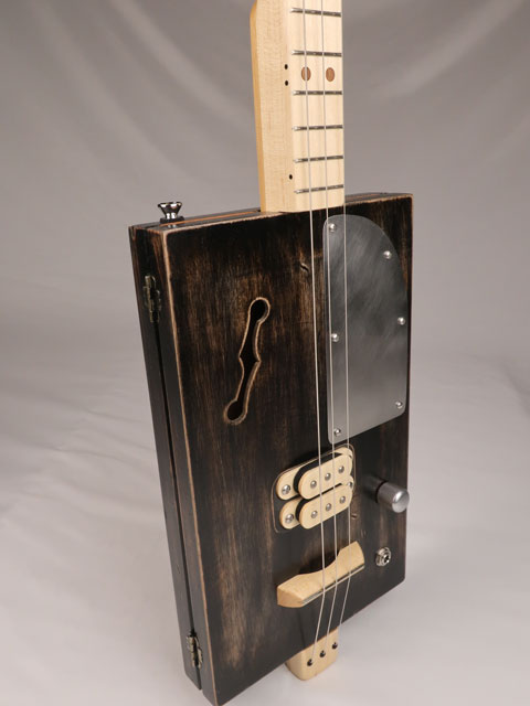 Front view of a 3 string cigar box guitar with a humbucker pickup. Handmade by Mike Snowden of Snowden Guitars.