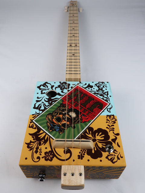 Island Jim 3 string cigar box guitar. Has a cool logo on the front of cigar box of a guy with a beard smoking a cigar with an Hawaiian fell and look.