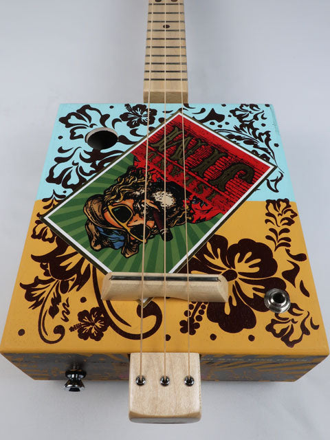 Cigar Box Guitar with Island Jim logo on the front and Hawaii feel and colors in the background. 