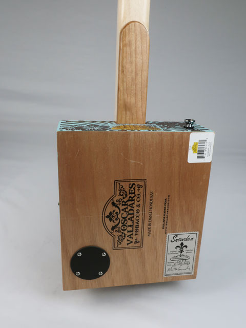 Back view of a cigar box guitar. Island Jim handmade by mike snowden with a Snowden Guitars logo and tag on the back.