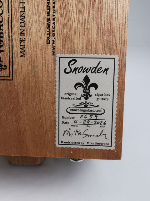 Cigar Box Guitar back view. With a Snowden Guitars sticker on the back showing the date and number of guitars made by the maker.