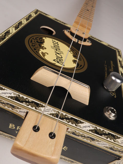 Front tilted view of a 2 string cigar box guitar made with a Brick House  cigar box. Handmade by Mike Snowden of Snowden Guitars.