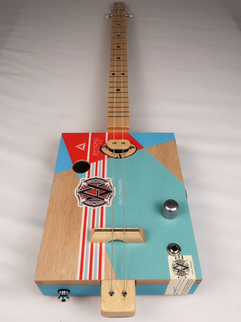 Front view of a 2 string cigar box guitar made with an AVO cigar box. Handmade by Mike Snowden of Snowden Guitars.