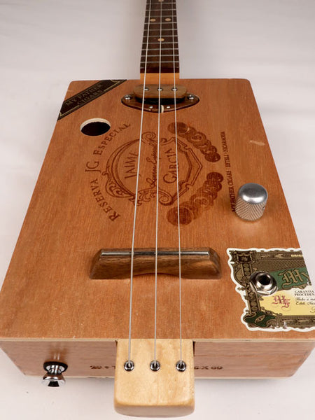 Front view of a 3 string cigar box guitar made with a Jaime Garcia cigar box. Handmade by Mike Snowden of Snowden Guitars.