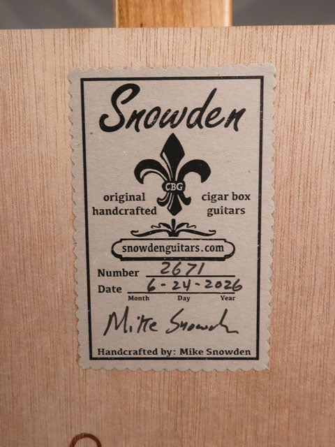 back view of a cigar box guitar with a Snowden Guitars logo on the back.