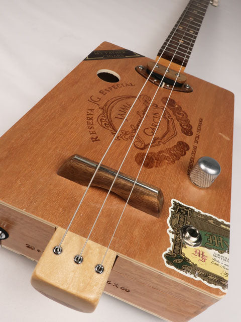 Front view of a 3 string cigar box guitar made with a Jaime Garcia cigar box. Handmade by Mike Snowden of Snowden Guitars.