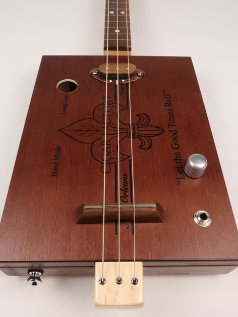 Front view of a 3 string cigar box guitar handmade by Mike Snowden of Snowden Guitars. This CBG is made with a New Orleans Cigar Factory cigar box.