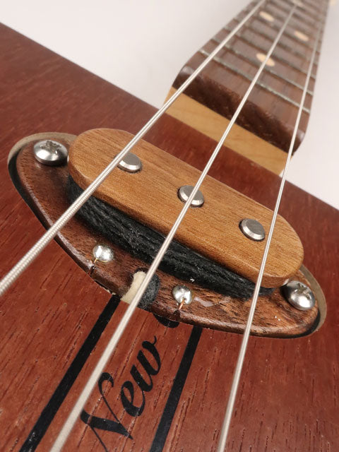 Close up view of a 3 string cigar box guitar single coil pickup handmade by Mike Snowden of Snowden Guitars. This 3 string pickup is made with walnut hard wood.