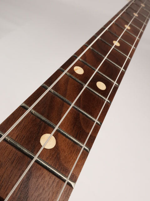 Front view of a 3 string cigar box guitar neck. Handmade by Mike Snowden of Snowden guitars with a walnut fret board and maple inlay.