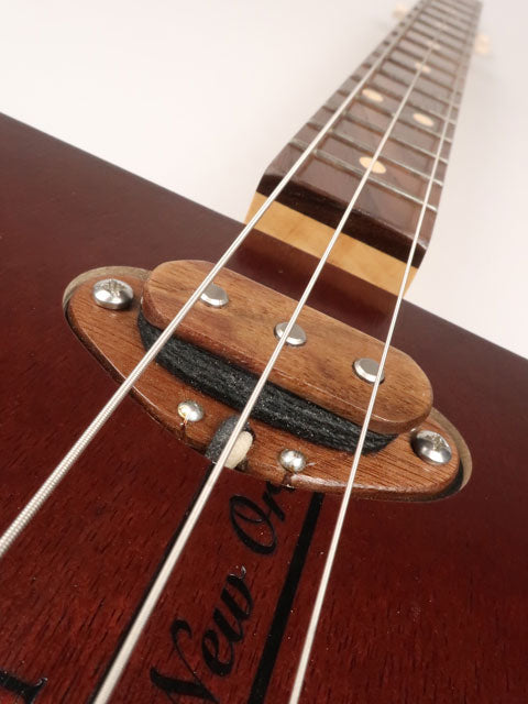 Close up view of a 3 string single coil pickup on a cigar box guitar handmade by Mike Snowden of Snowden Guitars.