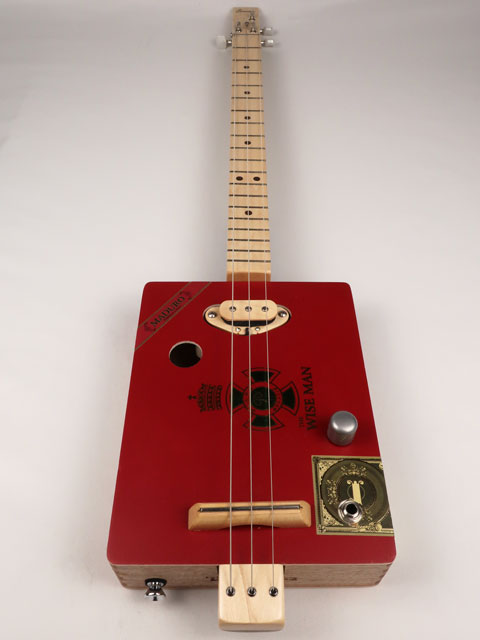 Front view of The Wise Man 3 string cigar box guitar handmade by Mike Snowden. This cigar box is made with a red cigar box with The Wise Man printed on the front.
