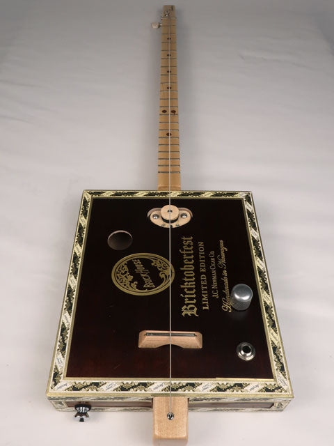 Front view of a one string diddly bow cigar box guitar cbg made with a Bricktoberfest cigar box. Handmade by Mike Snowden of Snowden Guitars.