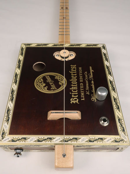 Front view of a one string diddly bow cigar box guitar cbg made with a Bricktoberfest cigar box. Handmade by Mike Snowden of Snowden Guitars.