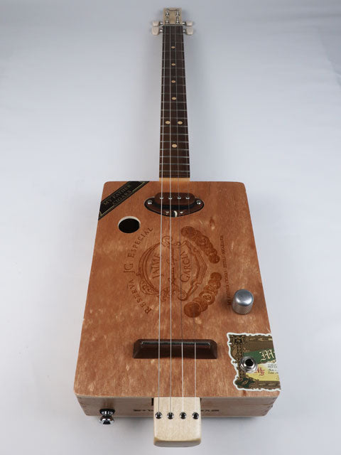 Front view of a Cigar Box Guitar handmade by Mike Snowden. This cigar box guitar is made from a Jaime Garcia cigar box with a walnut single coil pickup.