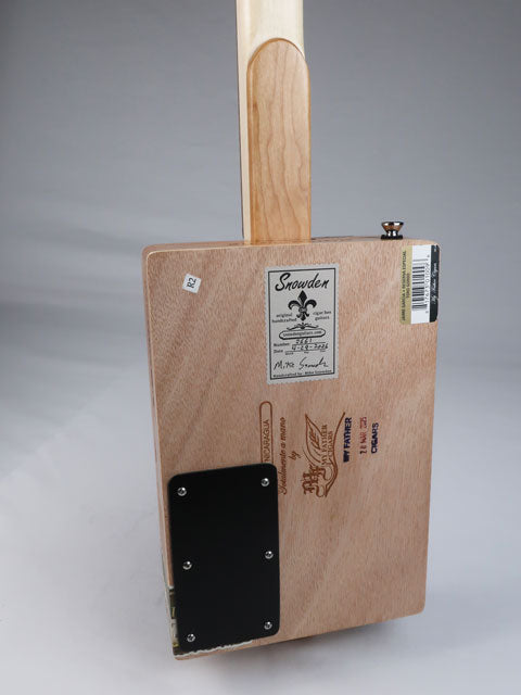 Back view of a cigar box guitar with a maple neck and a builder logo on the back. This cigar box guitar is handmade by Mike Snowden.