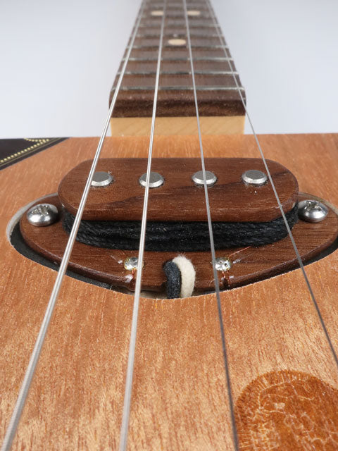 Close up view of a 4 string cigar box guitar pickup made front walnut. This cigar box guitar is handmade by Mike Snowden.