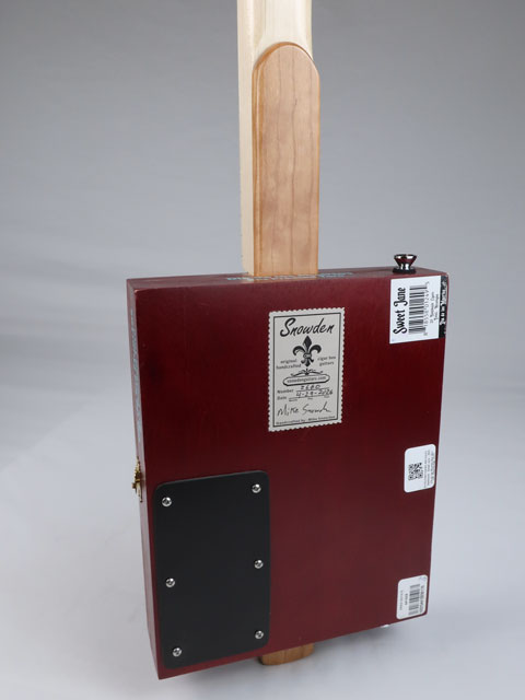 Back view of a red cigar box guitar with a Maple neck and Snowden Guitars logo on the back.